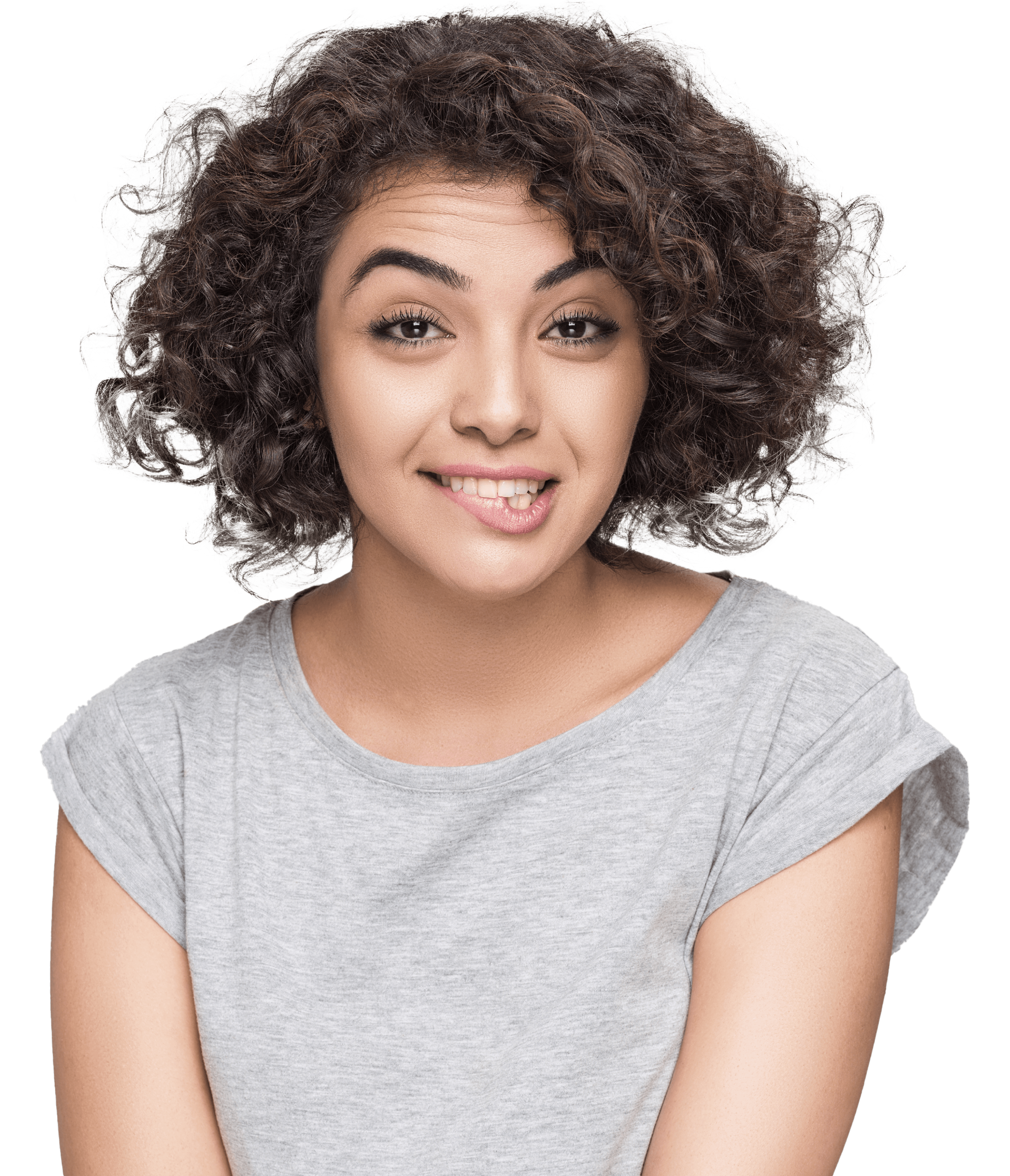 Young woman with curly hair, raises eyebrows, looks astonished